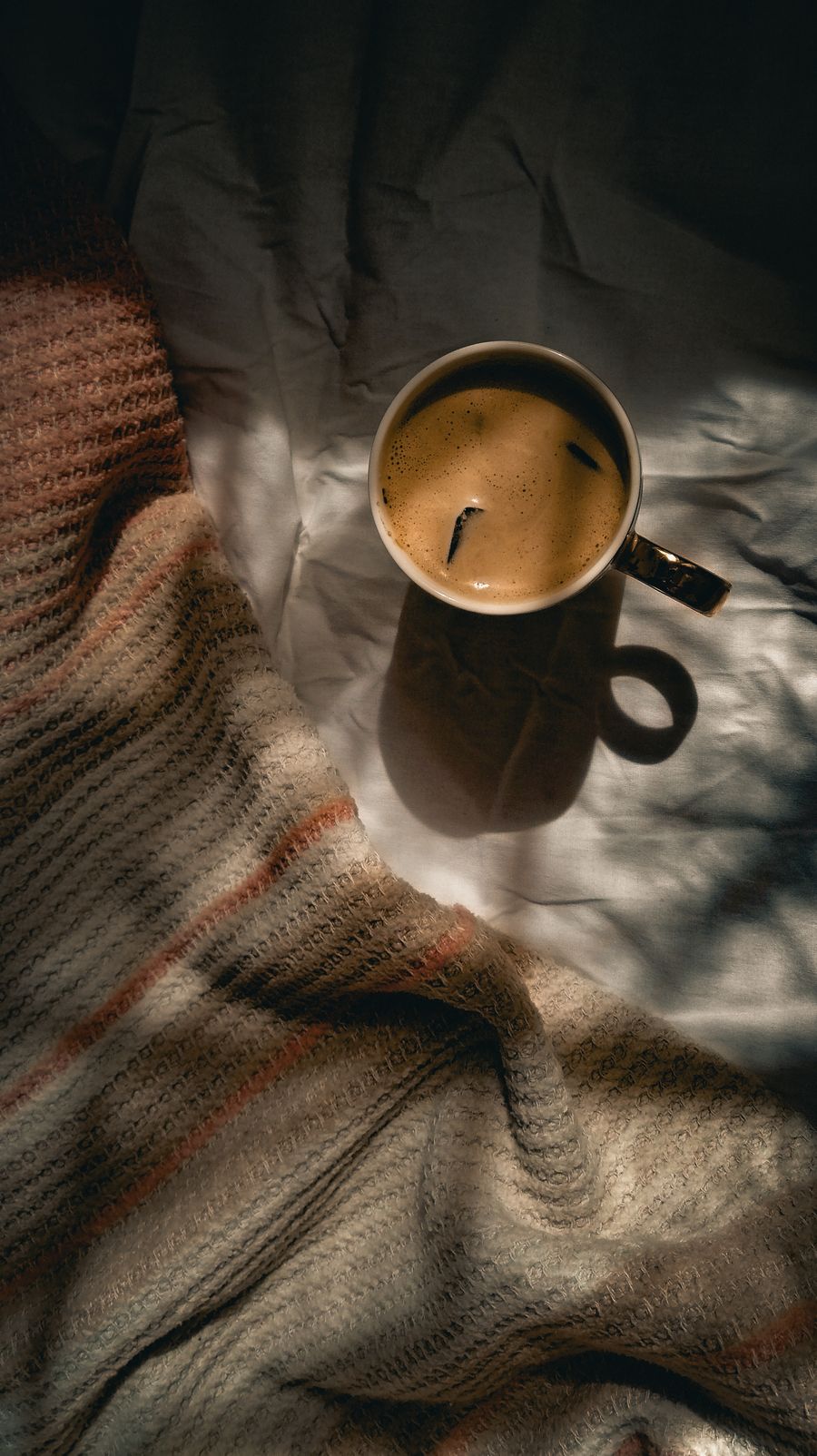 Cup of coffee on a cosy blanket