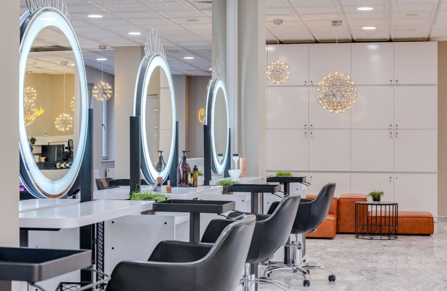 Salon chairs in front of round mirrors